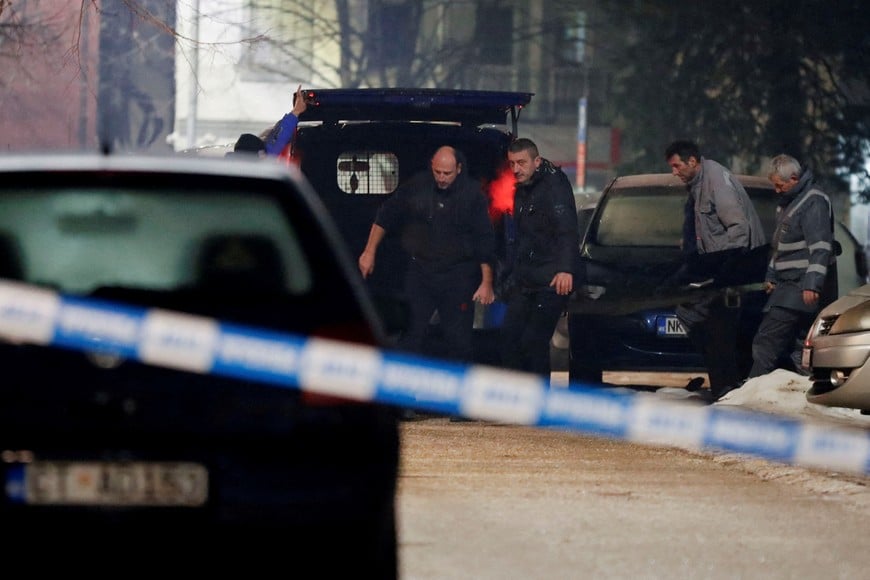 Workers carry a body after a gunman opened fire and killed several people in a restaurant in Cetinje, Montenegro, January 1, 2025. REUTERS/Stevo Vasiljevic     TPX IMAGES OF THE DAY