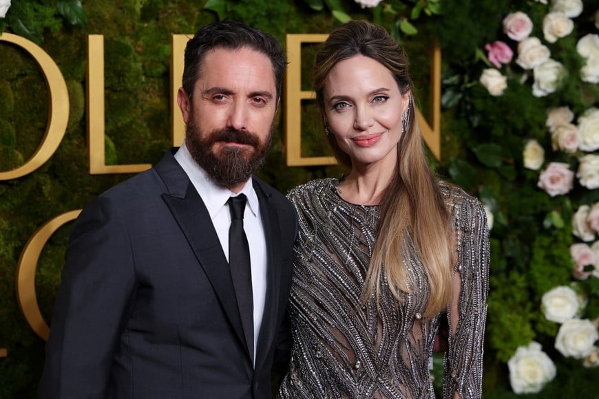 Angelina Jolie and Pablo Larrain attend the 82nd Golden Globe Awards in Beverly Hills, California, U.S., January 5, 2025. REUTERS/Daniel Cole