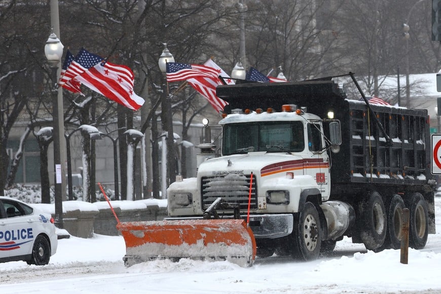 A snowplow vehicle clears snow from a street, as a winter storm that brought snow, ice and freezing temperatures to a broad swath of the U.S. hits Washington, U.S. January 6, 2025.   REUTERS/Fabrizio Bensch