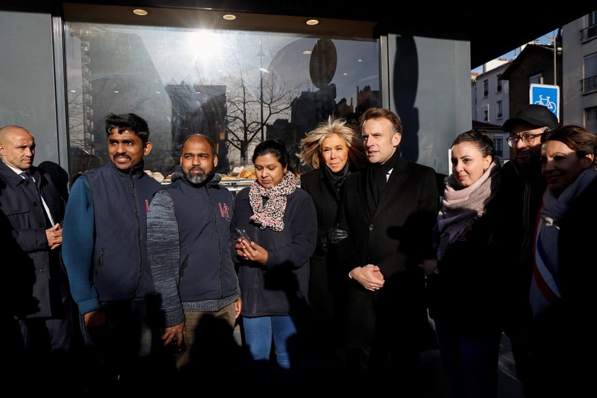 France's President Emmanuel Macron and his wife Brigitte pose with staff of the Hypercacher supermarket as they attend commemorations marking 10 years since an Islamist attack on the Charlie Hebdo satirical newspaper and the Hypercacher jewish supermarket in Paris, on January 7, 2025.     LUDOVIC MARIN/Pool via REUTERS