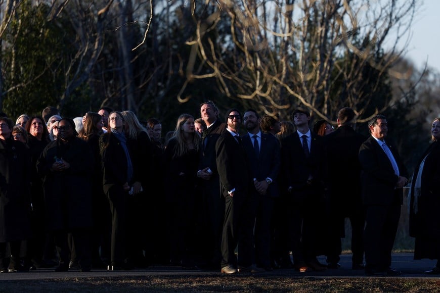 The family of former U.S. President Carter watch as the U.S. Navy performs a flyover, at Maranatha Baptist Church during a private funeral service in Plains, Georgia, U.S. January 9, 2025.  REUTERS/Alyssa Pointer