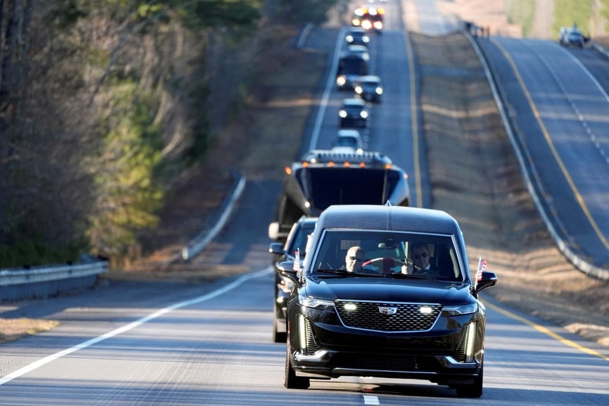 The hearse containing the flag-draped casket of former U.S. President Jimmy Carter is driven from the Lawson Army Airfield, in Fort Moore, GA, to the Maranatha Baptist Church, on the day of his funeral in Plains, Georgia, U.S., January 9, 2025.     Alex Brandon/Pool via REUTERS