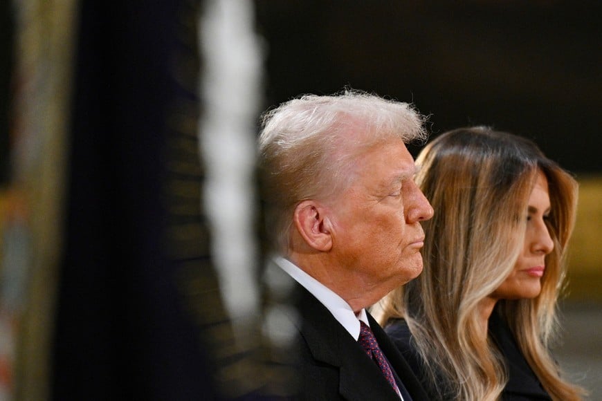 U.S. President-elect Donald Trump and Melania Trump visit the flag-draped casket of U.S. President Jimmy Carter, as he lies in state in the U.S. Capitol Rotunda in Washington, DC, U.S., January 8, 2025. REUTERS/Jon Cherry