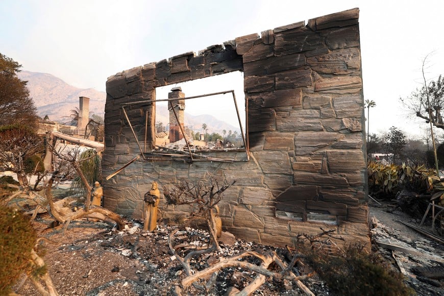 Property damaged by the Eaton Fire lie in ruin, while a pair of massive wildfires menacing Los Angeles from the east and west were still burning uncontained, in Altadena, California, U.S. January 9, 2025. REUTERS/Mario Anzuoni