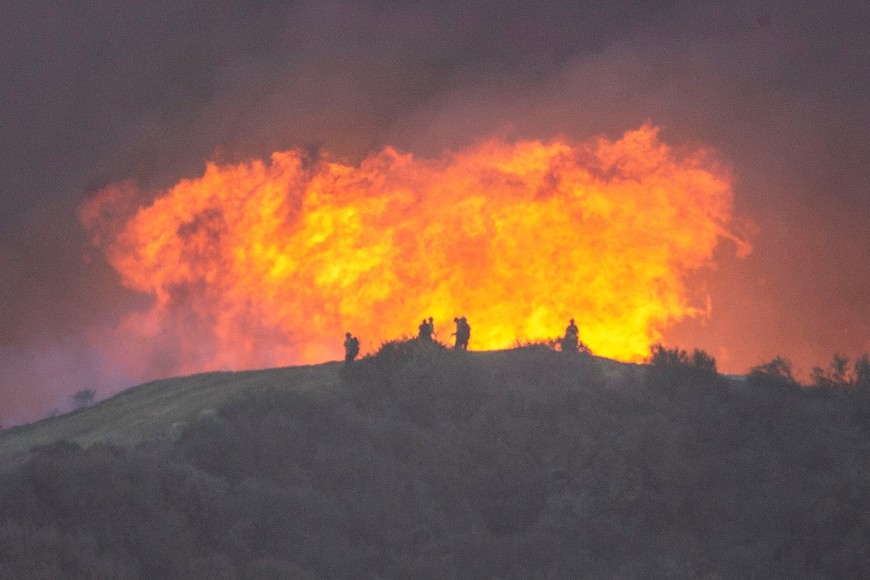 Firefighters battle the Palisades Fire, one of simultaneous blazes that have ripped across Los Angeles County, as seen from the Tarzana neighborhood of Los Angeles, California, U.S. January 11, 2025. REUTERS/Ringo Chiu     TPX IMAGES OF THE DAY