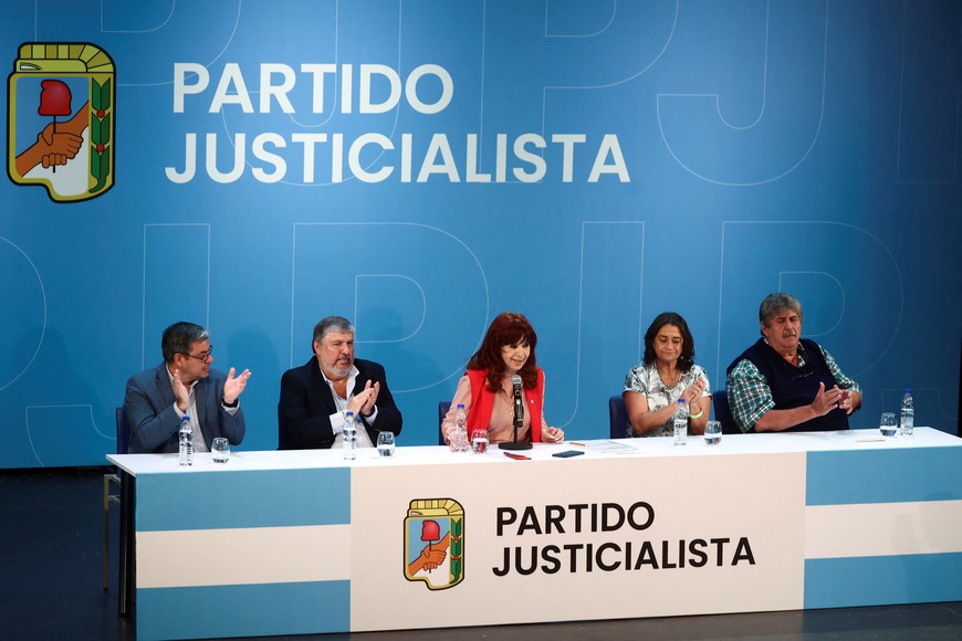 Argentina's Former President Cristina Fernandez de Kirchner speaks next to German Martinez, Jose Mayans, Lucia Corpacci and Ricardo Pignanelli during a rally for Kirchner to assume the presidency of the Peronist opposition Justicialist Party, in Buenos Aires, Argentina, December 11, 2024. REUTERS/Tomas Cuesta