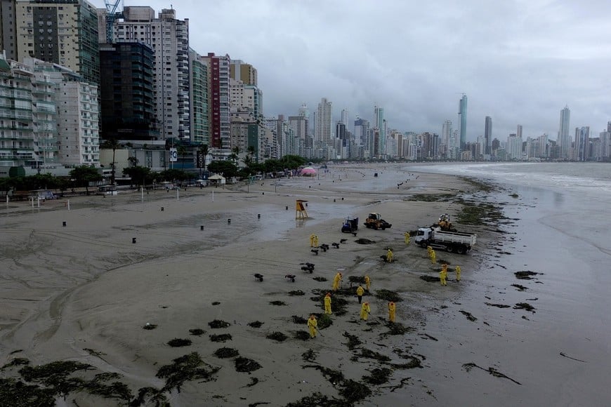 A drone view shows cleaners working at the Central Beach after heavy rains in Balneario Camboriu, in Santa Catarina state, Brazil January 17, 2025. REUTERS/Anderson Coelho