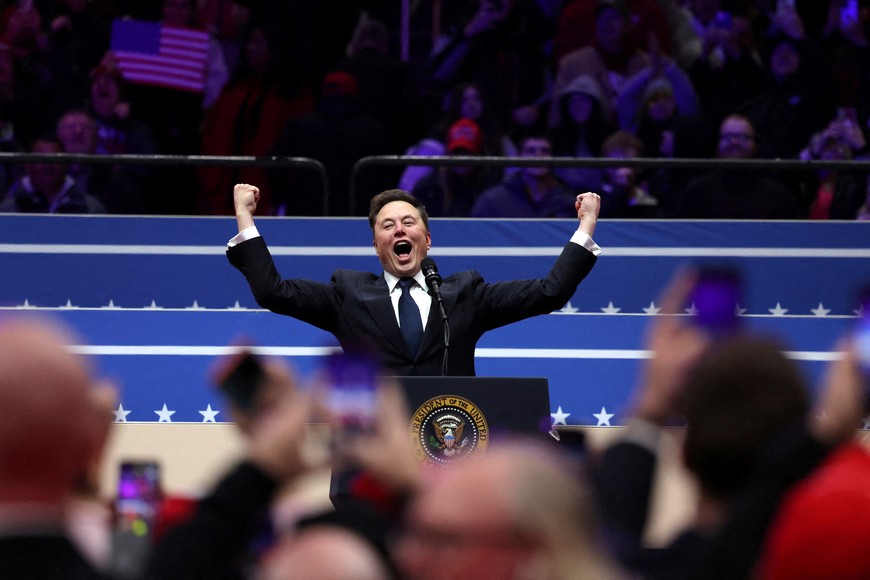 Tesla CEO and X owner Elon Musk gestures on stage as he prepares to speak inside the Capital One arena on the inauguration day of Donald Trump's second Presidential term, in Washington, U.S., January 20, 2025. REUTERS/Amanda Perobelli