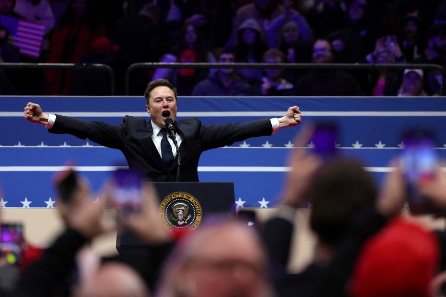 Elon Musk gestures as he speaks inside the Capital One arena on the inauguration day of Donald Trump's second presidential term, in Washington, U.S., January 20, 2025. REUTERS/Amanda Perobelli