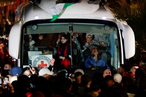 Freed Palestinian prisoners ride in a bus after their release from an Israeli jail as part of a hostages-prisoners swap and a ceasefire deal in Gaza between Hamas and Israel, outside the Israeli military prison, Ofer, near Ramallah, in the Israeli-occupied West Bank, January 20, 2025. REUTERS/Ammar Awad