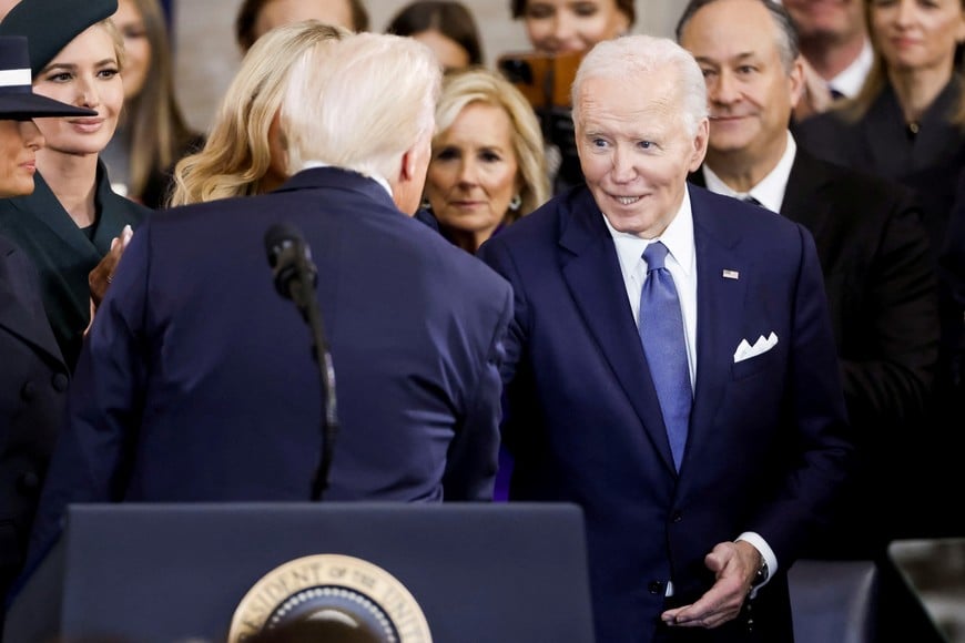 Former US President Joe Biden (R) congratulates US President Donald Trump (L) after he was sworn in during an inauguration ceremony in the rotunda of the United States Capitol in Washington, DC, USA, 20 January 2025. Trump, who defeated Kamala Harris, is being sworn in today as the 47th president of the United States, though the planned outdoor ceremonies and events have been cancelled due to a forecast of extreme cold temperatures.    SHAWN THEW/Pool via REUTERS