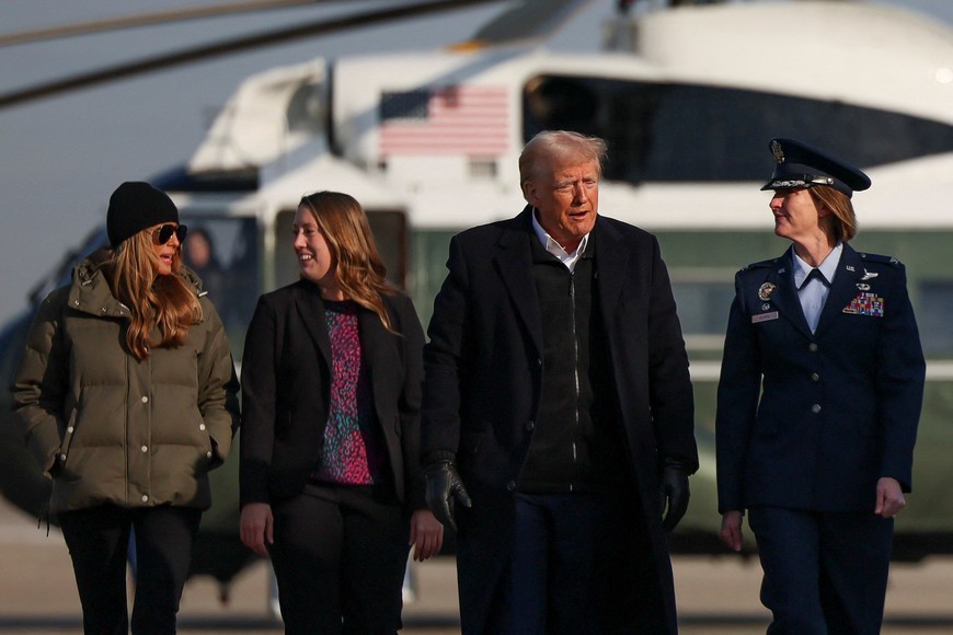 U.S. President Donald Trump and first lady Melania Trump walk on the tarmac to board Air Force One as they depart for North Carolina at Joint Base Andrews in Maryland, U.S., January 24, 2025. REUTERS/Leah Millis