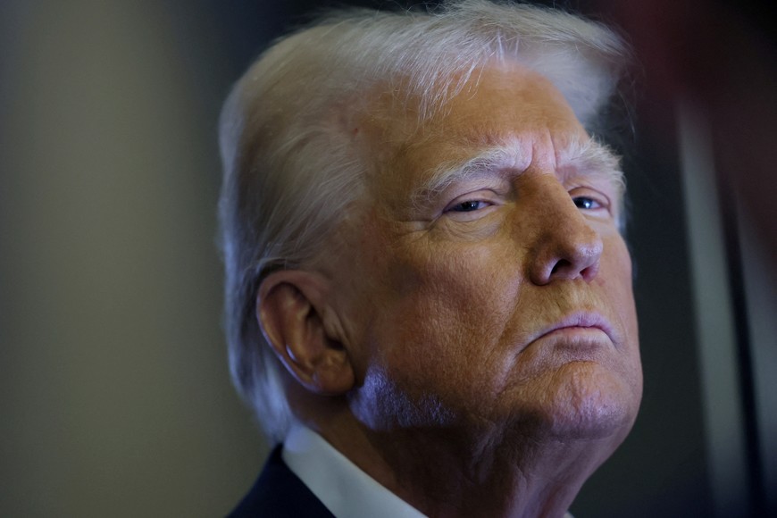 FILE PHOTO: U.S. President Donald Trump looks on as reporters ask questions aboard Air Force One during a flight from Las Vegas, Nevada, to Miami, Florida, U.S., January 25, 2025. REUTERS/Leah Millis/File Photo