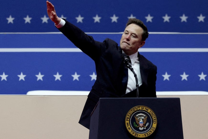 FILE PHOTO: Elon Musk gestures at the podium inside the Capital One arena on the inauguration day of Donald Trump's second presidential term, in Washington, U.S., January 20, 2025. REUTERS/Mike Segar/File Photo