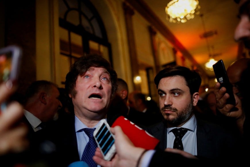 Ramiro Marra, candidate for mayor of Buenos Aires and part of the inner circle of Argentina's radical presidential front-runner Javier Milei, listens to Milei talking to journalists, in Buenos Aires, Argentina August 24, 2023. REUTERS/Agustin Marcarian