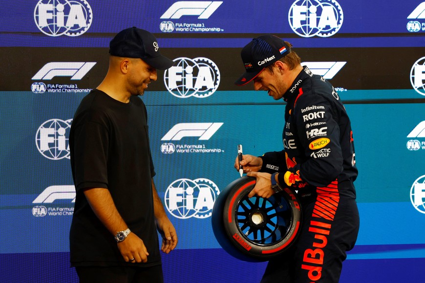 Formula One F1 - Abu Dhabi Grand Prix - Yas Marina Circuit, Abu Dhabi, United Arab Emirates - November 25, 2023
Red Bull's Max Verstappen celebrates after qualifying in pole position with former footballer Sergio Aguero REUTERS/Rula Rouhana