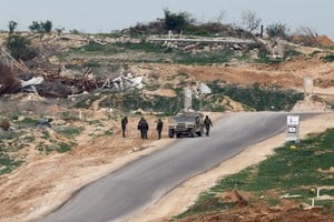 Israeli soldiers stand next to a military vehicle in Gaza, amid a ceasefire between Israel and Hamas, as seen from Israel, February 9, 2025. REUTERS/Amir Cohen