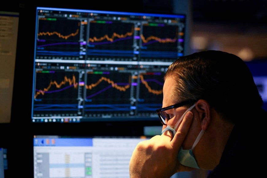 FILE PHOTO: A trader works on the trading floor on the last day of trading before Christmas at the New York Stock Exchange (NYSE) in Manhattan, New York City, U.S., December 23, 2021. REUTERS/Andrew Kelly/File Photo