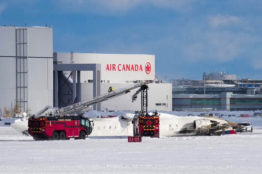 First responders work at the Delta Air Lines plane crash site at Toronto Pearson International Airport in Mississauga, Ontario, Canada February 17, 2025. REUTERS/Arlyn McAdorey     TPX IMAGES OF THE DAY