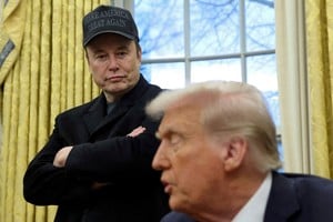 FILE PHOTO: Elon Musk listens to U.S. President Donald Trump speak in the Oval Office of the White House in Washington, D.C., U.S., February 11, 2025.   REUTERS/Kevin Lamarque/File Photo