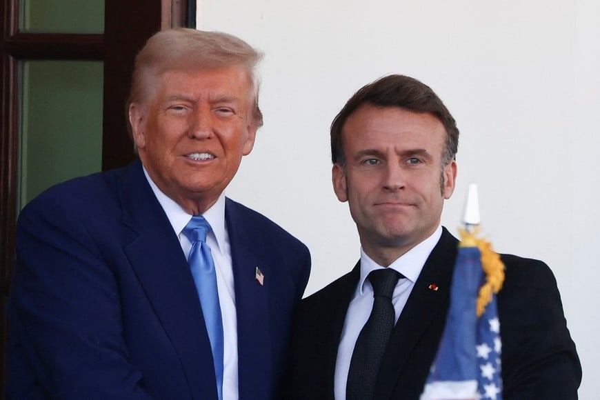 U.S. President Donald Trump and French President Emmanuel Macron pose on the day of a meeting, at the White House in Washington, D.C., U.S., February 24, 2025. REUTERS/Evelyn Hockstein