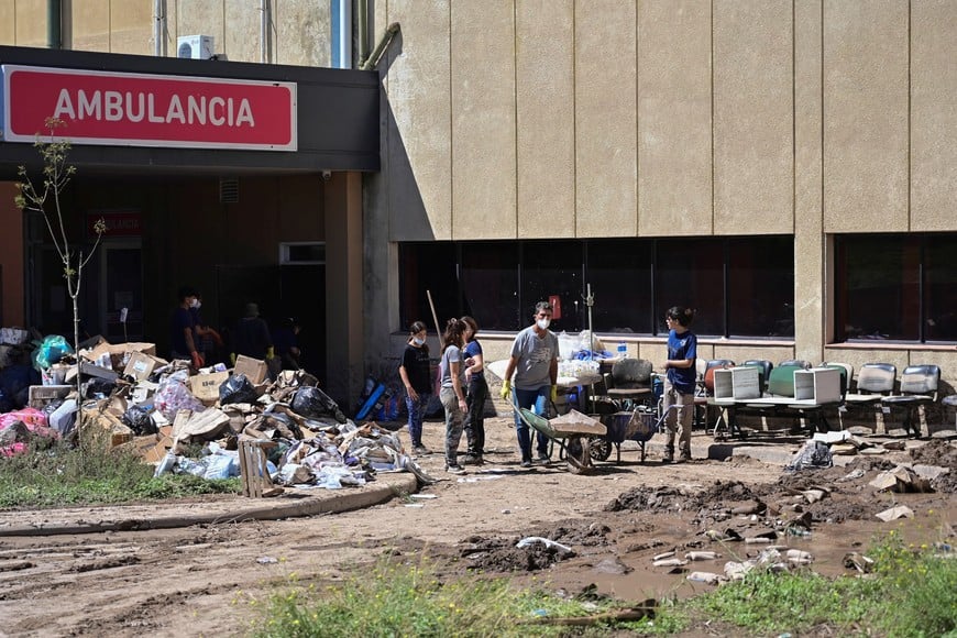 People clean up outside the Jose Penna Interzonal Hospital, after a flood struck the city of Bahia Blanca, in the province of Buenos Aires, Argentina March 9, 2025. REUTERS/Juan Sebastian Lobos