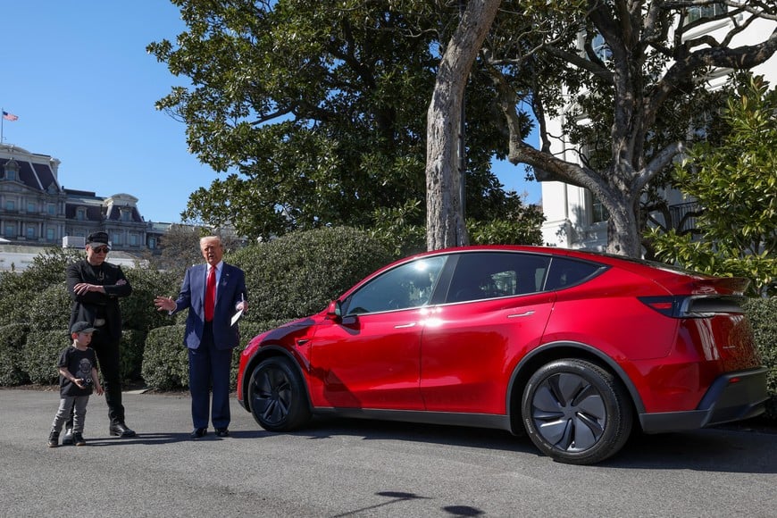 U.S. President Donald Trump talks to the media, next to Tesla CEO Elon Musk with his son X Æ A-12, at the White House in Washington, D.C., U.S., March 11, 2025. REUTERS/Kevin Lamarque