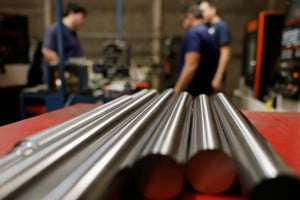 Workers stand near steel bars at a metal-mechanical parts factory with application to industry, as U.S. President Donald Trump will impose tariffs on steel and aluminum, in Apodaca, Mexico, March 11, 2025. REUTERS/Daniel Becerril